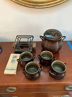 Full set showing pot with lid, 4 bowls, metal rack, candle box
