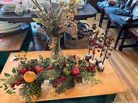 Overall view of two small floral arrangements, tall bouquet in Paul Masson bottle and four bell-tree stems