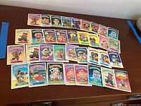Front view of all ~40 Garbage Pail Kids cards laid out in rows