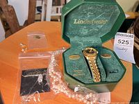 Watch in open Lindenwold box with jewelry pieces in plastic bags