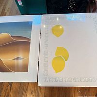 Both signed prints side by side for scale and content overview
