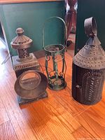 All three lanterns grouped on floor showing relative sizes and styles