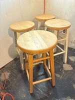 Four stools grouped together showing seats and leg condition
