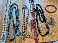 All seven jewelry pieces laid out on table
