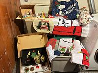 Lot overview showing Snoopy rugs, door mat, nativity figures, tray and glass holders
