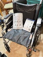 Front view of Medline wheelchair showing seat, armrests, legrest mounts, and manuals
