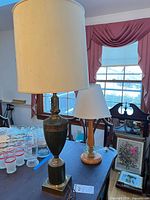 Both table lamps with cream shades on table