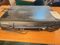 Front view of Panasonic PV-V4022 VHS VCR with dust and power cord visible