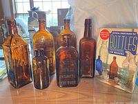 Group shot of six amber glass bottles showing shapes and sizes