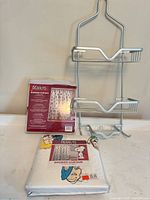 Front and back packages of Peanuts shower curtains and metal shower caddy