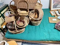 Overall view of green futon frame and mattress with other items placed on top