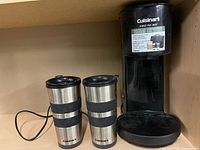 Coffee maker and two stainless travel mugs