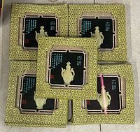 Five packaged framed jade artworks front view