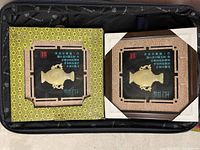 Two framed jade carving plaques in suitcase