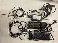 Assorted cables, battery charger, adapters, Shark battery pack