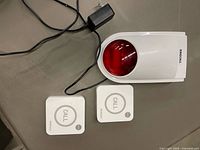 Front view of receiver, power cord, and two call buttons