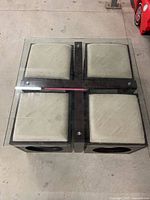 Overhead view of glass coffee table with four stools fitted inside