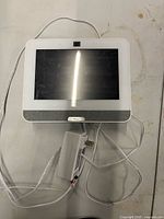 Front view of white Qolsys IQ Panel showing touchscreen and speaker grille