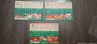 Back view of all three cards displaying statistics, cartoons, and card numbers