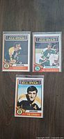 Front view of three 1974 Topps All-Star hockey cards in sleeves