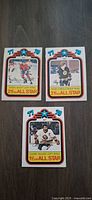 Front view of three 1978 O-Pee-Chee All Star hockey cards (Shutt, O’Reilly, Gillies)