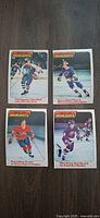 Front view of four 1978 O-Pee-Chee NHL Highlights cards showing players Esposito, Unger, Lafleur, Canadiens highlight