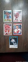 overview of all five hockey rookie cards laid out on wood surface