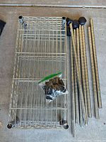 All components laid out: shelf, poles, casters, slip sleeves