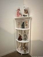 Full view of corner shelf showing all nine rabbit figurines