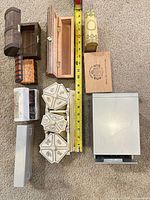 Top view of all wooden boxes, resin trinket chest, metal file cabinet, tape measure for scale