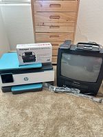 Group shot showing HP printer, Emerson CRT TV/VCR with remote and cords, boxed Kaito Voyager radio