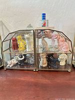 Full view of glass case with all figurines displayed