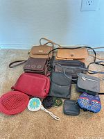 Group shot of all purses and pouches on carpet
