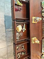 Drawers open showing multiple cat figurines in various materials