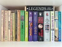 Single shelf view showing all 18 books spine-out