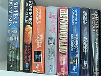 Spine view of nine Stephen R. Donaldson titles and anthology, showing publisher logos and wear