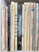 Shelf showing spines of approximately 20 illustrated and fantasy reference books