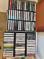 Open storage briefcase showing two full drawers of cassettes