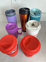 Group shot of all seven travel mugs and tumblers