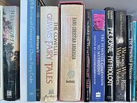 Shelf view showing 11 book spines including Grimm’s Fairy Tales editions, Hans Christian Andersen, Women Who Run With the Wolves and others