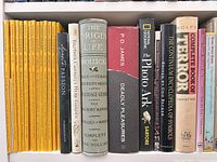 Shelf row with National Geographic magazines, Photo Ark, Deadly Pleasures, gardening, symbolism, terror and other hardcovers