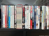 Front view of all DVD spines showing approximately 24 titles in cases