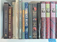 Shelf view of first group of books showing spines, titles and wear