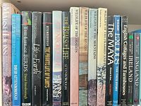 Shelf view of wildlife, Attenborough, habitat series and travel hardcovers showing spines and dust jackets