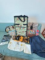 Group shot of all bags, pouches, organizer, door stop alarm, straps