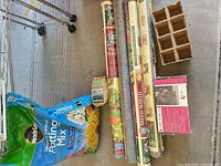 Group shot: four landscape fabric rolls, potting mix bag, Jiffy seed starter package, peat pot tray visible