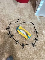 Black elastic clothesline with clips and yellow pencil pouch