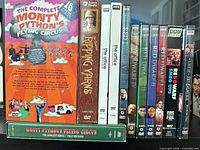 Group shot of all video releases standing upright showing titles and formats