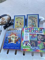 Group shot of all items: carved display, DK pack, Magnetic Mosaics box, two Brainteaser puzzle boxes