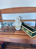 Overview of all items on shelf: two glass planters on stands, ceramic cat fountain, painted wood planter